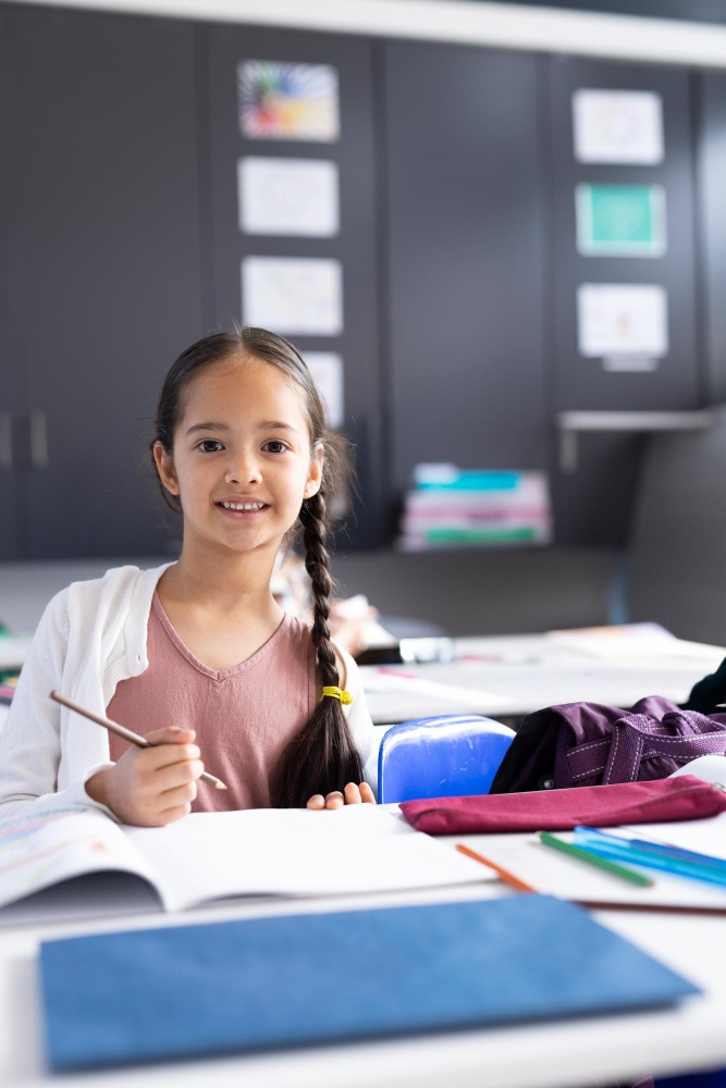 Young girl opening and writing in book
